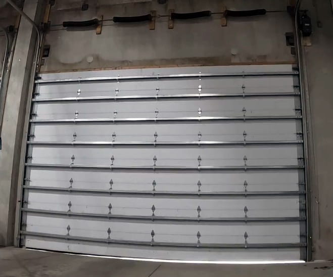 commercial sectional garage door we repaired at a Sacramento warehouse